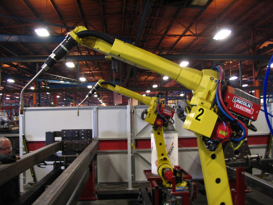 Industrial robot arms on a factory line representing broader multi-industry robotics demand